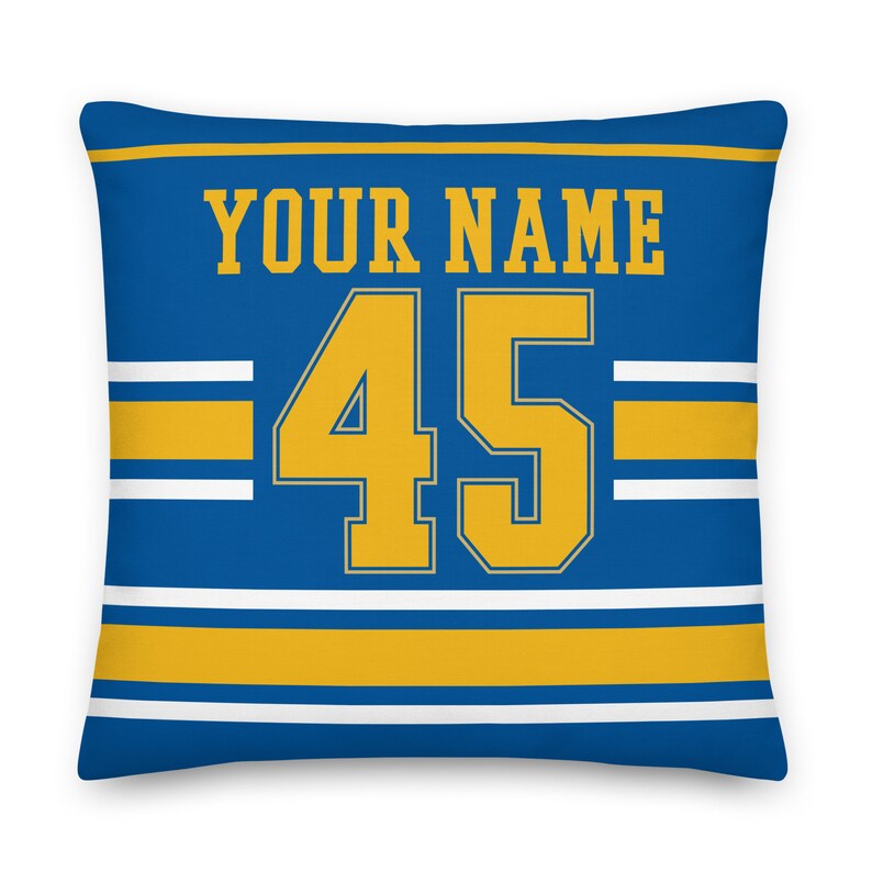 May include: Blue and gold personalized pillow with the text "YOUR NAME" and the number "45" in a jersey style.