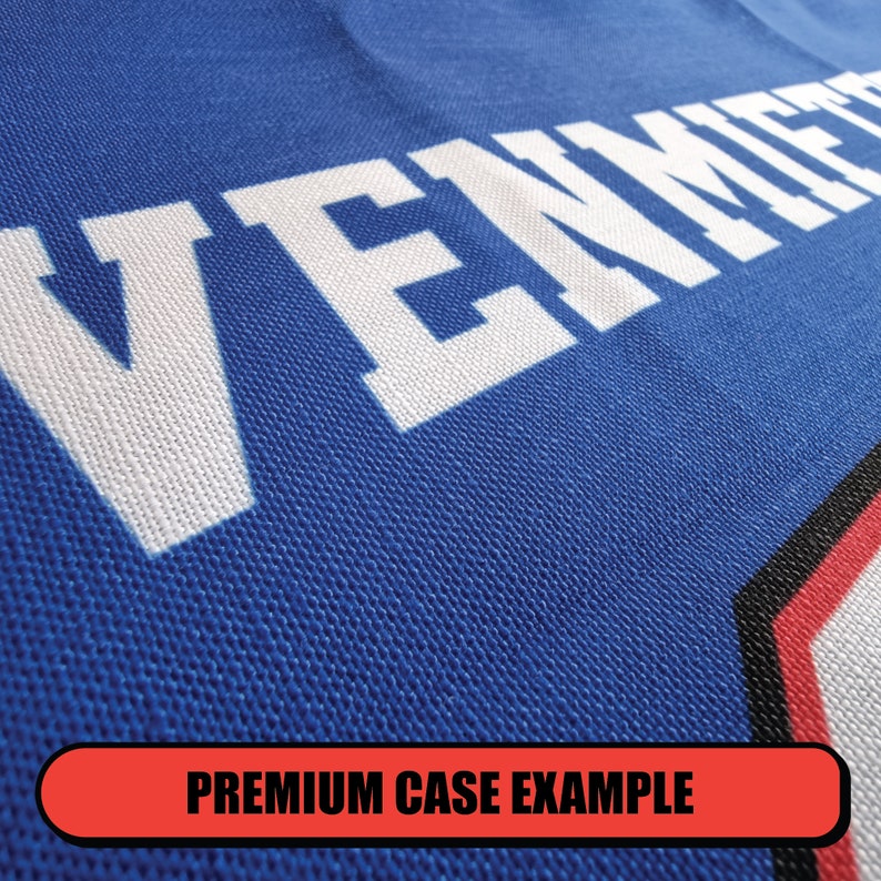 May include: Close-up of a blue fabric with the word "VENICE" printed in white. The fabric has a textured, woven appearance.