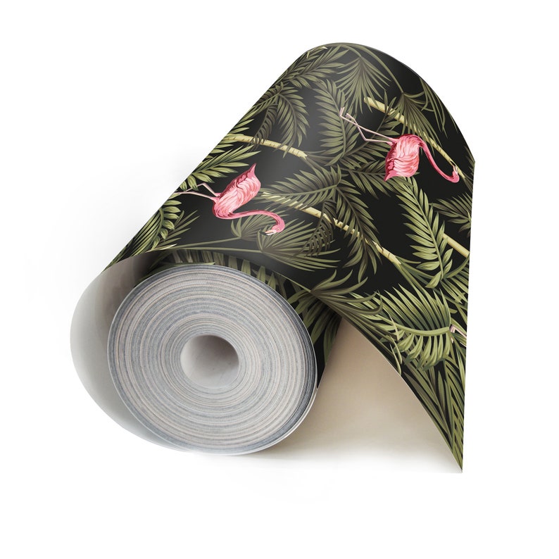 May include: A roll of black and green wallpaper with a tropical leaf pattern and pink flamingos.