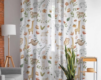 May include: A pair of white curtains with a whimsical pattern of animals and plants. The pattern includes giraffes, elephants, owls, sloths, rabbits, and leaves in shades of brown, orange, and green.
