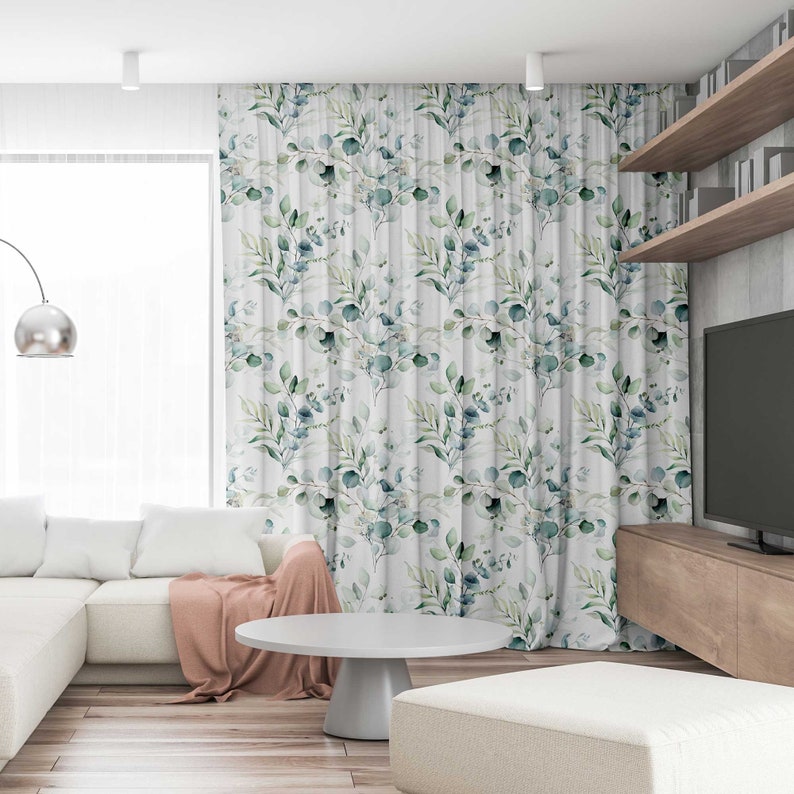 May include: White curtains with a repeating pattern of green and blue watercolor leaves and branches.
