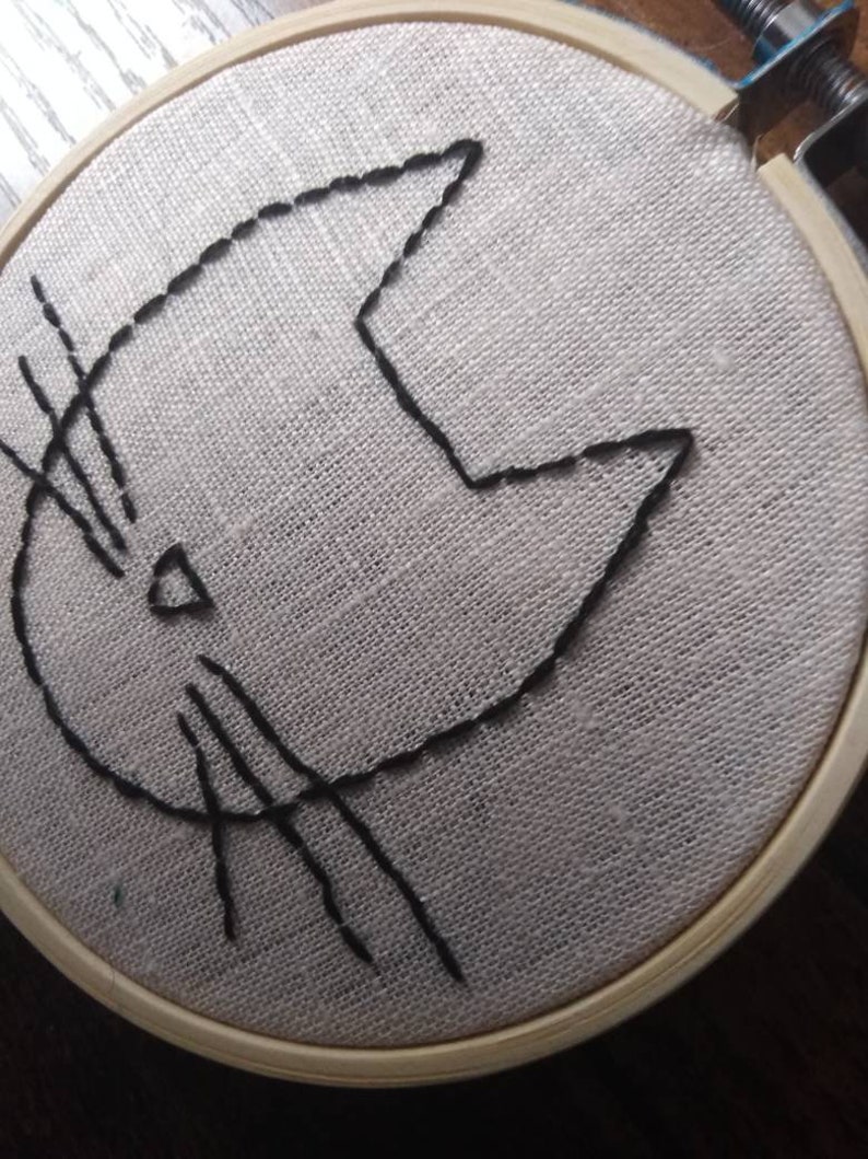 Hand embroidery of a minimalist cat head