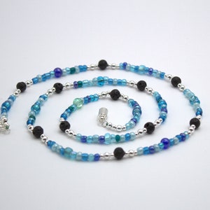 Striking blue, black, and silver sea foam themed beaded necklace