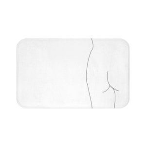 May include: A white bath mat with a simple line drawing of a person's back and hips.