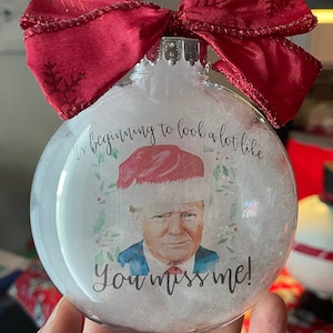Trump Christmas ornament. Funny Trump Santa. Beginning to look a lot like you miss me. Red Bow, Plastic disc Christmas Ornament