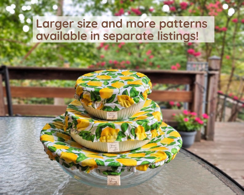 May include: Three round glass bowls stacked vertically, each covered with a fabric bowl cover featuring a yellow lemon and green leaf pattern. Each cover has a small rectangular tag. Text reads: Larger size and more patterns available in separate listings!