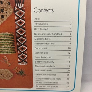 May include: A book titled "Contents" with a list of craft projects, including macrame, beadwork, and string art. The book features images of various crafts, such as a macrame doormat, a beaded bracelet, and a string-covered bottle.