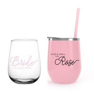 May include: Two pink tumblers with a straw. One tumbler says "Bride on Cloud Wine" and the other says "Stop & Smell the Ros&eacute;".