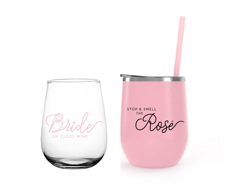 May include: Two pink tumblers with a straw. One tumbler says "Bride on Cloud Wine" and the other says "Stop & Smell the Ros&eacute;".