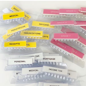 May include: A set of three ceramic mugs with a speckled, matte finish. The mugs are in shades of cream, light gray, and dark gray. Each mug has a simple, minimalist design and a rounded handle.