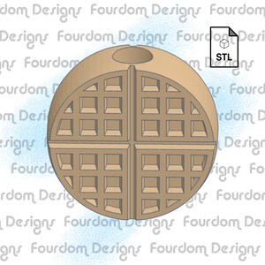 Op de afbeelding: Een 3D-geprint model van een wafelbal. De bal is gemaakt van vier wafelstukken, elk met een rasterpatroon. De bal heeft een gat in het midden.