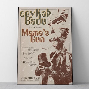 May include: A rectangular poster featuring Erykah Badu with the text Mama's Gun, featuring the hit singles Bag Lady, Cleva, and Didn't Cha Know. The design uses a sepia-toned colour palette with a portrait of the artist wearing a headwrap and glasses.