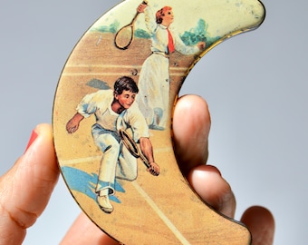 Vintage crescent shaped lithograph tin with Edwardian tennis players.