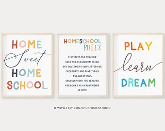 May include: Three colorful printable wall art prints with text. The first print says "Home Sweet Home School" in a rainbow of colors. The second print says "Homeschool Rules" and lists rules for homeschooling. The third print says "Play Learn Dream" in a rainbow of colors.