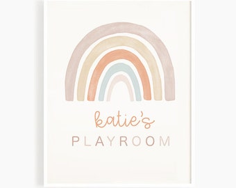 May include: A white framed print with a watercolor rainbow in shades of pink, orange, and blue. The text "katie's PLAYROOM" is below the rainbow.