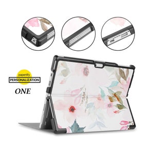 May include: A black case with a floral design for a Microsoft Surface tablet. The case has a kickstand and is designed to protect the tablet.