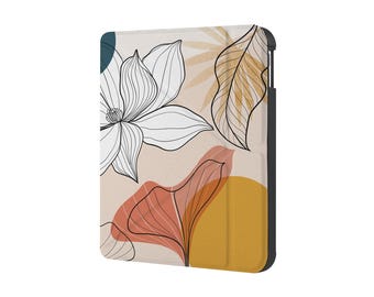 Puede incluir: Funda para tableta con diseño floral. La funda presenta una gran flor blanca con contornos negros, formas de hojas naranjas y amarillas y un círculo verde azulado sobre un fondo beige. La funda tiene un borde negro.
