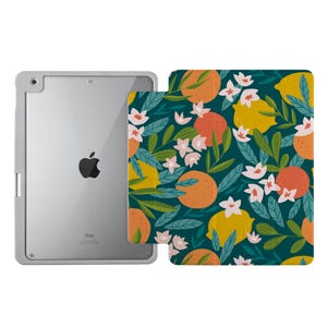May include: A teal iPad case with a floral pattern featuring lemons, oranges, and white flowers. The case is designed to fit an iPad.