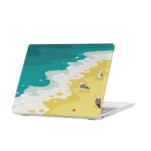 May include: White laptop with a beach scene on the lid. The scene features blue water, white waves, and yellow sand with four seagulls.
