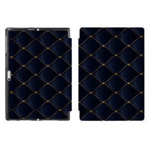 May include: A black tablet case with a gold quilted pattern. The case has a flap that covers the screen and a cutout for the camera.