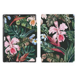 May include: A black tablet case with a tropical floral print. The design showcases large pink orchids, white and blue flowers, and green leaves on a dark backdrop. The case is designed to protect the tablet while adding a stylish touch.