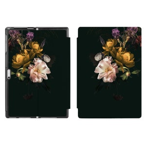 May include: A black phone case with a floral design featuring pink and yellow flowers on a dark green background.