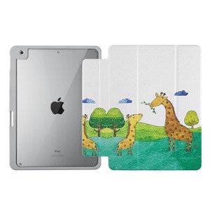 May include: A white iPad case with a colorful illustration of three giraffes in a green field. The case has a white background with a green field and blue clouds. The giraffes are drawn in a cartoon style with brown spots and yellow necks. The case has a cutout for the iPad camera and a flap that folds over the screen.