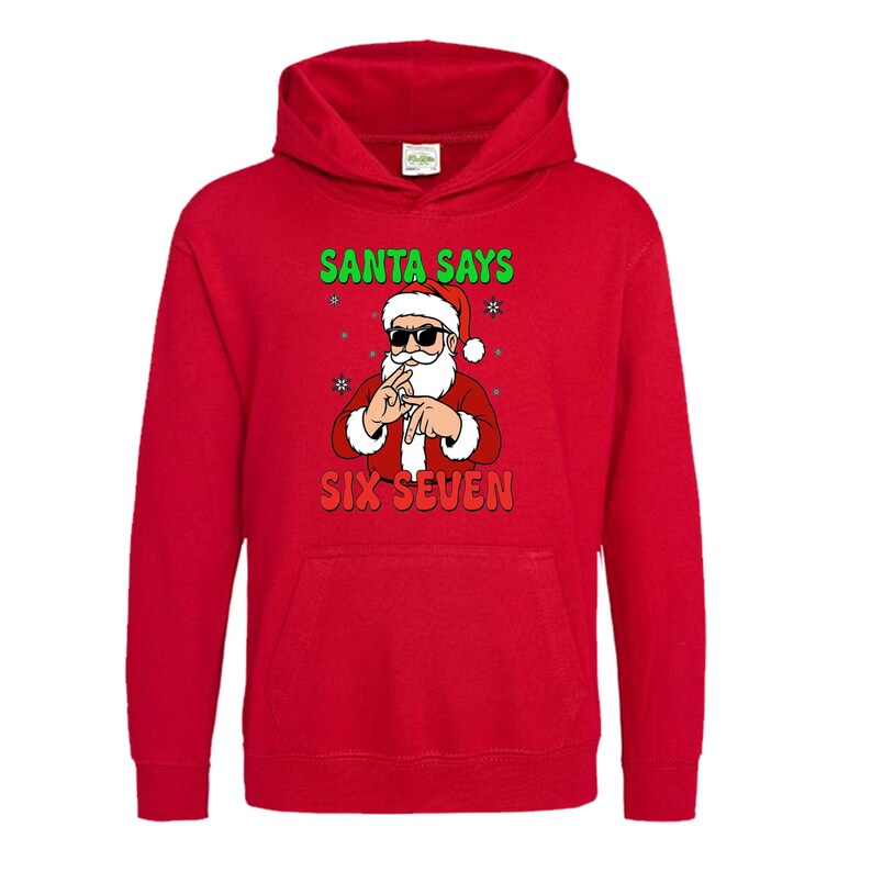 May include: A red hooded sweatshirt featuring a graphic of Santa Claus wearing sunglasses and making a hand gesture. The text "SANTA SAYS" is above the Santa graphic, and "SIX SEVEN" is below.