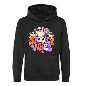 May include: A black hooded sweatshirt featuring a graphic print of three white ghosts wearing heart-shaped sunglasses, a disco ball, and the text "SPOOKY VIBES" in orange, purple, and pink bubbly lettering, accented with small pink and orange stars.