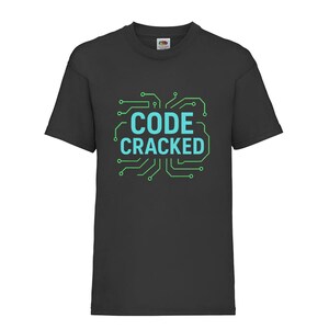 May include: A black short-sleeved t-shirt featuring a graphic print on the chest. The design consists of light blue text that reads CODE CRACKED, surrounded by a green circuit board pattern that frames the lettering in a square shape.