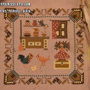 May include: Cross stitch pattern depicting a brown and white farmhouse kitchen with a rooster, chickens, and a girl wearing a red dress with brown hair. The text "ITCHY_PRINCESS_BLACK" is in the top left corner.