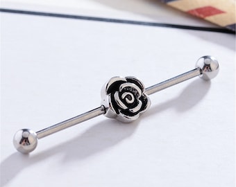 May include: Silver barbell with a black rose charm on one end and a silver ball on the other end.