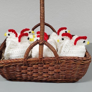 May include: A wicker basket filled with crocheted white chicks with red and yellow accents.
