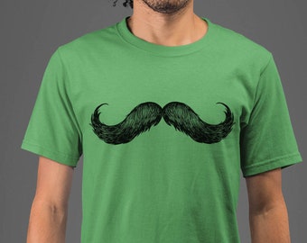 May include: A green t-shirt with a black and white illustration of a mustache.