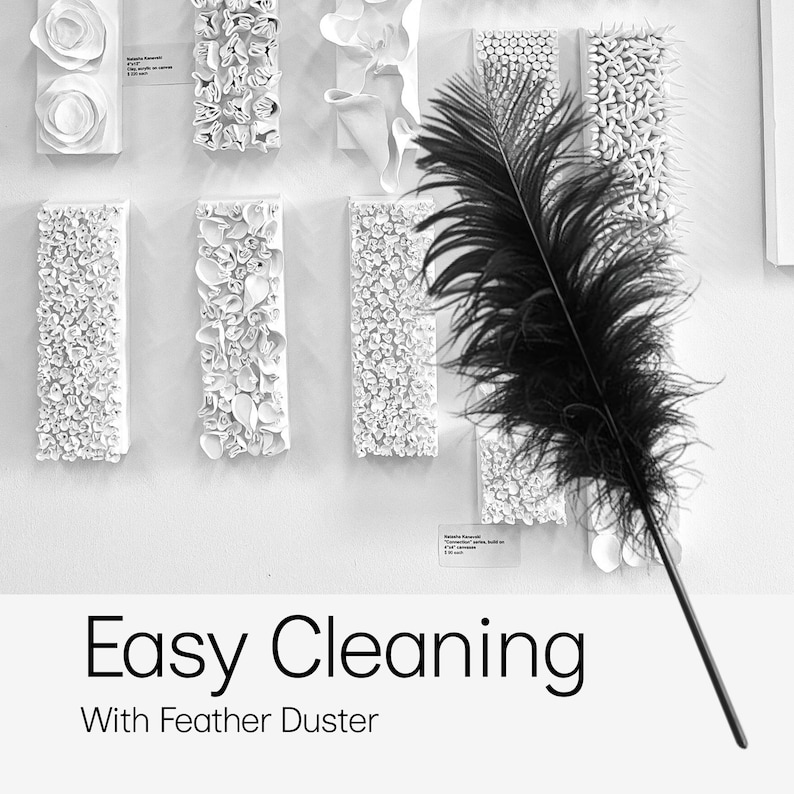 May include: A black feather duster with a long handle is displayed in front of white wall art. The wall art consists of various white, textured, rectangular pieces. The text "Easy Cleaning With Feather Duster" is at the bottom.