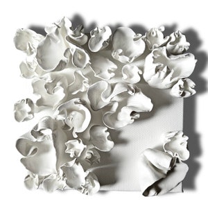 May include: A square, white canvas with textured, three-dimensional, abstract floral art. The sculpted, petal-like forms are clustered and layered, creating a dynamic, artistic composition. The artwork is set against a white background.