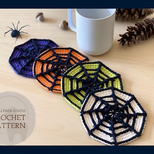 May include: Four handmade crochet coasters in a spiderweb design. The coasters are in shades of purple, orange, green, and cream, with black web detailing. A white mug and a decorative spider are also in the image. The text "MY ALPACA STUDIO CROCHET PATTERN" is visible.
