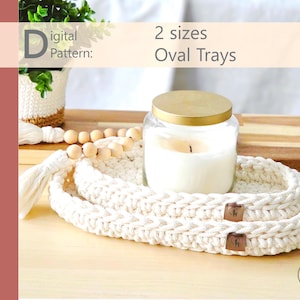 May include: A digital pattern for two sizes of oval trays. The image shows a white crocheted tray with a candle in a glass jar with a gold lid. A wooden tray and decorative beads are also visible.