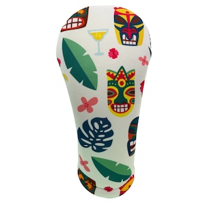 May include: White golf head cover with a tropical print featuring tiki masks, green leaves, pink flowers, and a yellow cocktail glass.