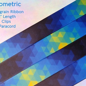 May include: Four strips of geometric patterned grosgrain ribbon in blue, yellow, and green. The ribbon is 9-12 inches long and comes with KAM clips and 550 paracord.