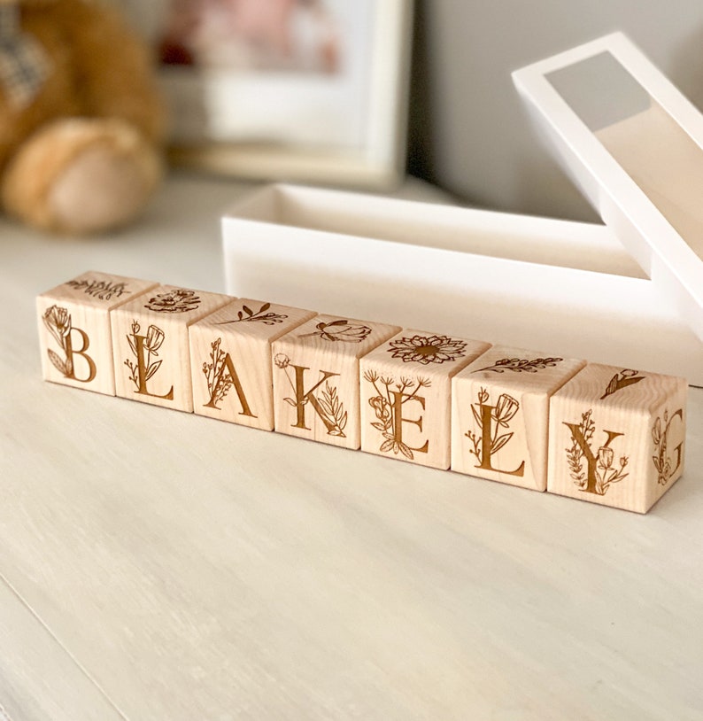 Floral themed personalized wooden baby name alphabet blocks with plant and floral graphics for baby room decor made of solid hardwood wooden baby toy gift custom name option gift box included gift message
