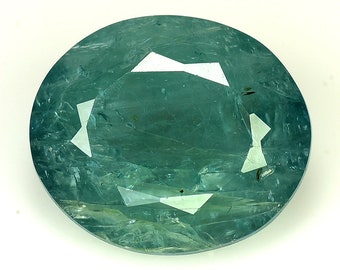 May include: A green oval gemstone with a faceted cut. The gemstone has a light green color and a translucent appearance.
