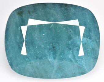 May include: A teal blue gemstone with a cushion cut and a white, geometric design etched on the surface.