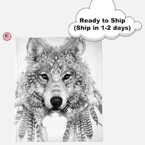 May include: A black and white blanket featuring a detailed illustration of a wolf's face with intricate tribal patterns and feathers. The text "Ready to Ship" is in a cloud-shaped speech bubble.