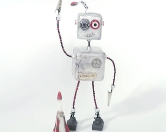 Retro robot sculpture with rocket ship, handmade robot assemblage