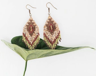 Mid-length ethnic style earrings. Colors turquoise blue or green, bronze, cream, brick red