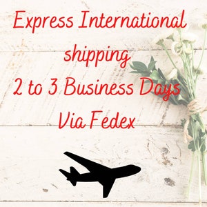 May include: Image with red text on a white wooden background. The text reads "Express International shipping 2 to 3 Business Days Via Fedex." A black silhouette of an airplane is at the bottom.