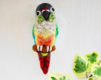 Needle felted pin of a Green cheek conure facing front