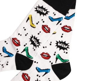 May include: A pair of white socks with a black cuff. The socks have a colorful pattern of lips, high heels, and the word "WOW" repeated throughout.