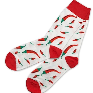 May include: A pair of white socks with a red chilli pepper pattern. The socks have red cuffs.